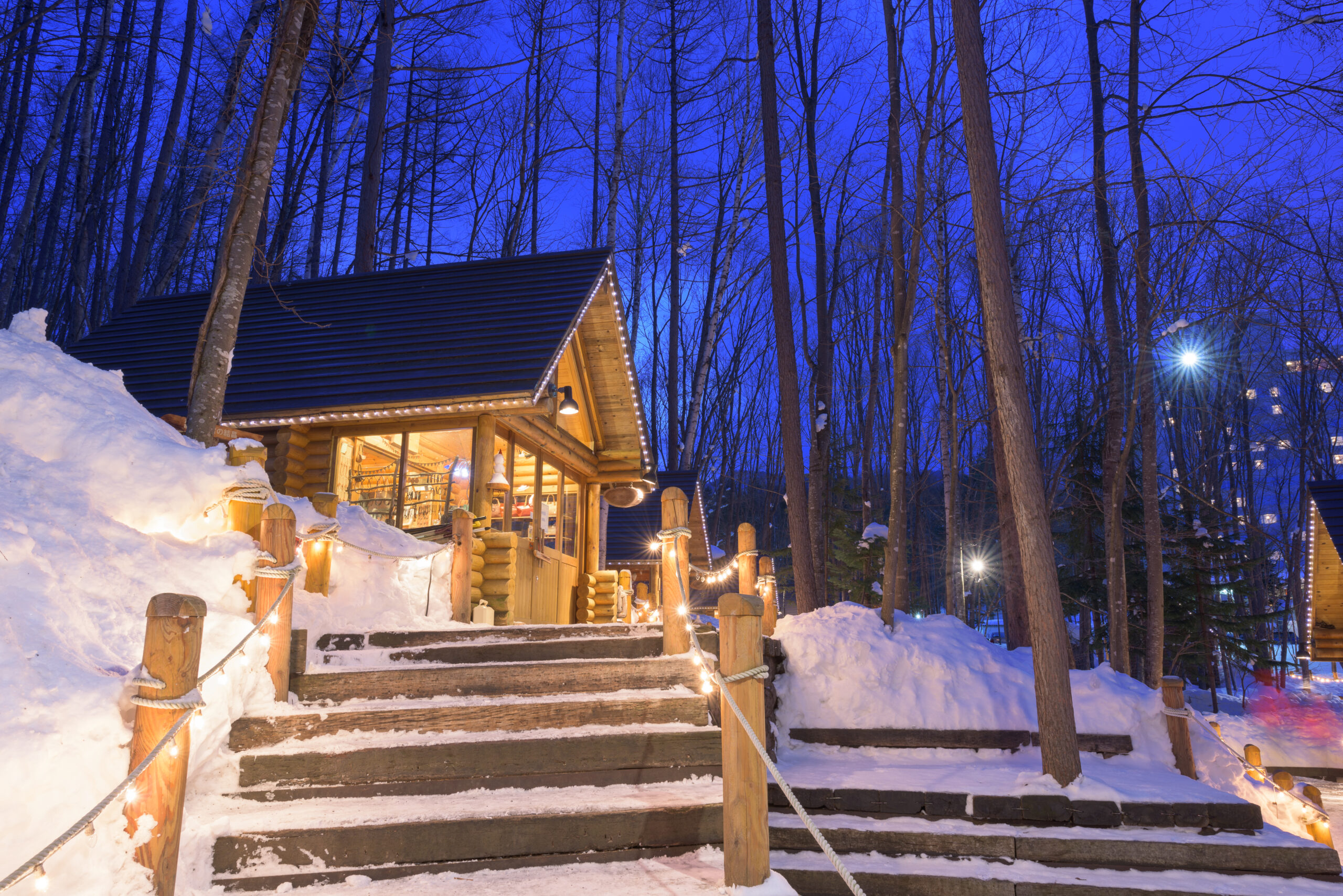 Quaint winter cabin surrounded by snow.