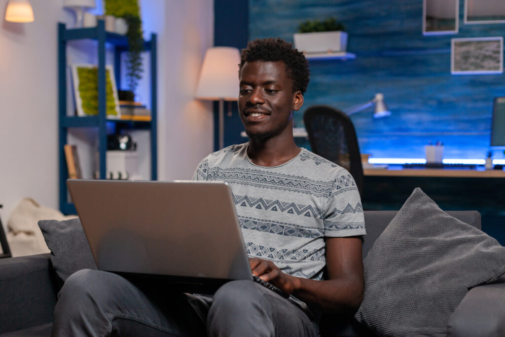 Person sitting on the couch using a laptop.