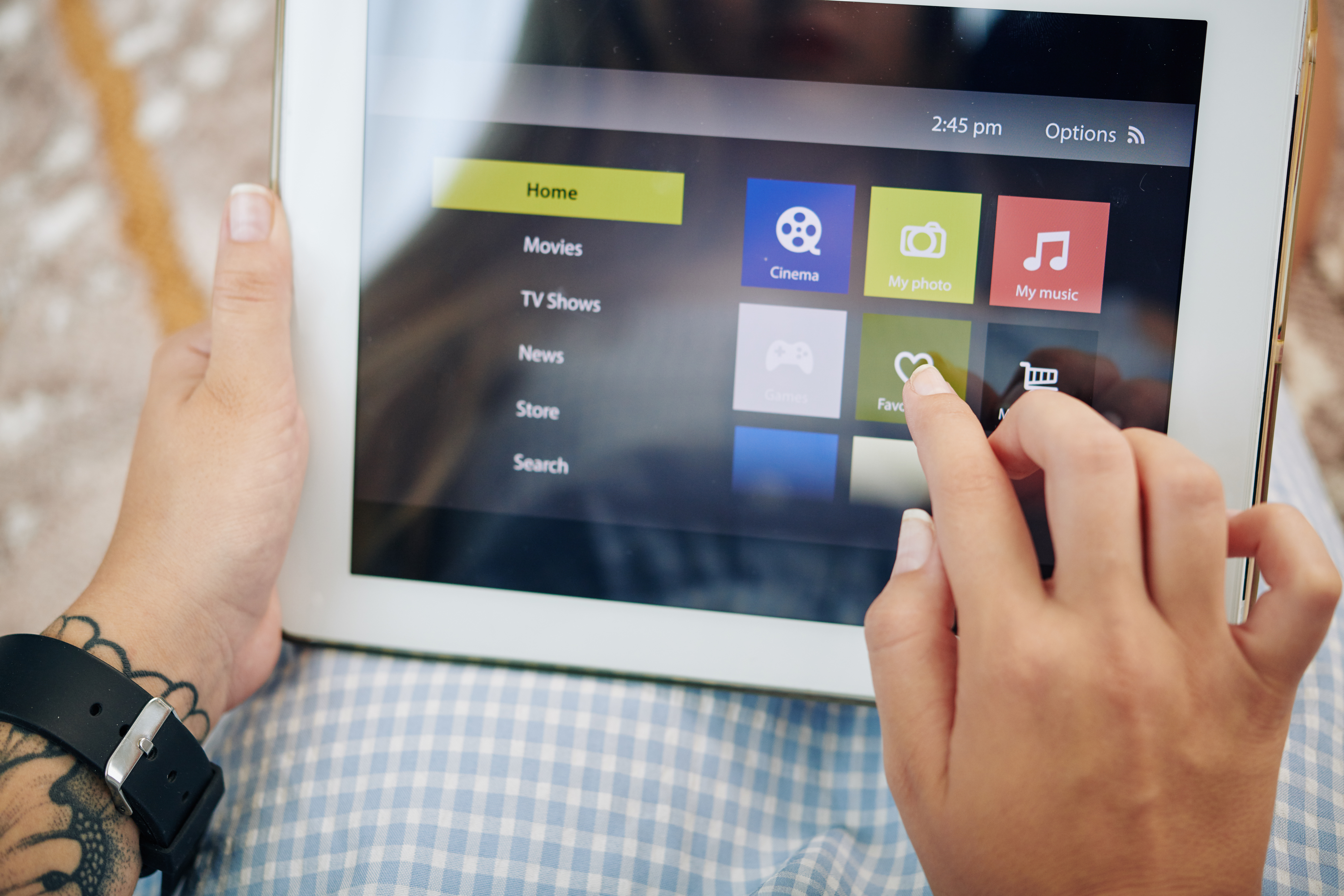 Close-up of a woman using a tablet with generic applications.