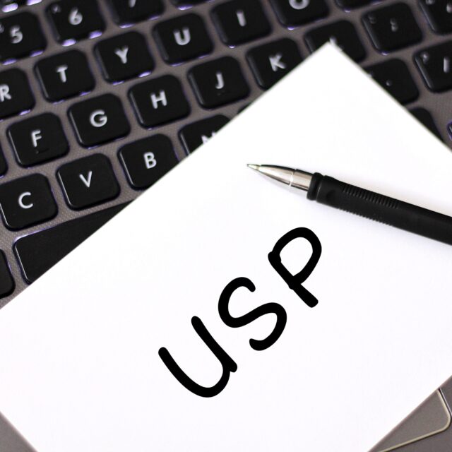 A piece of white paper with the letters "USP" written on it.